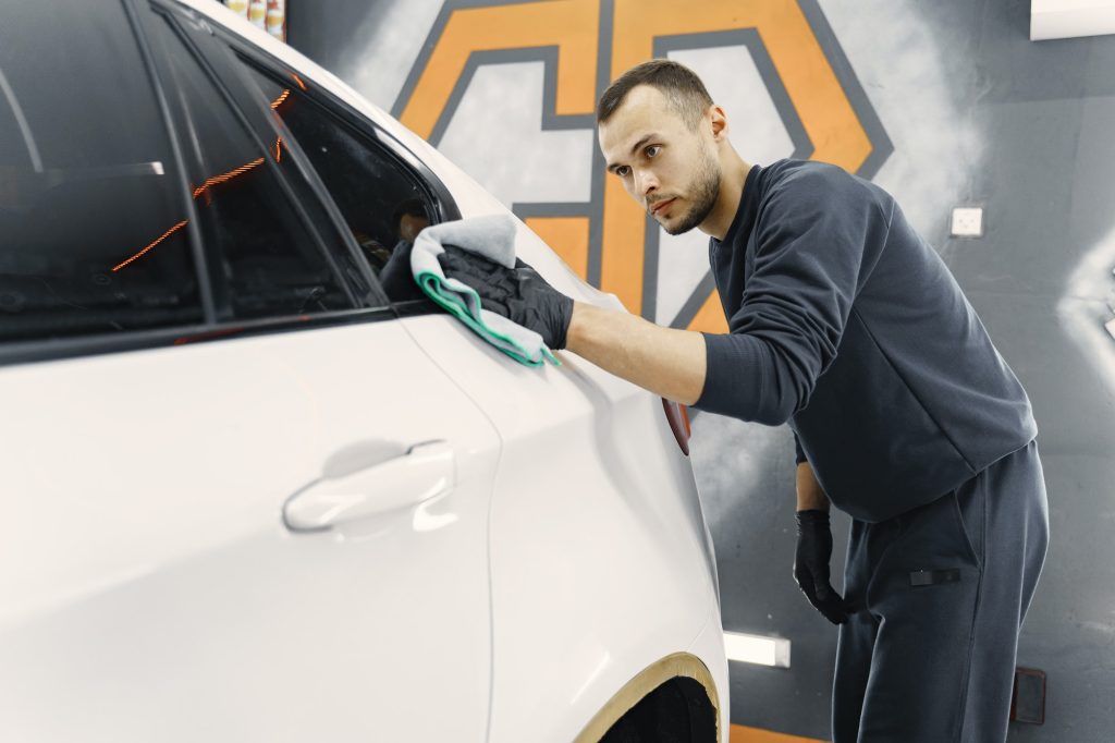 a man cleaning a car